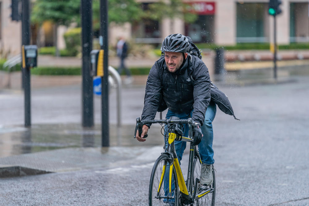 Man-cycling-in-the-rain